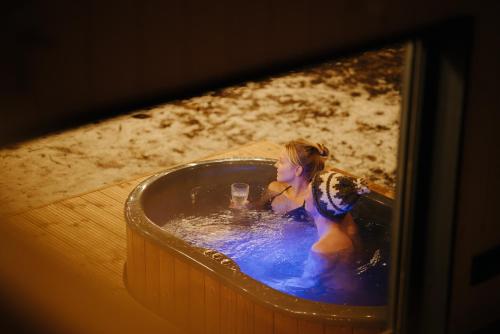 a little girl sitting in a bath tub at Living art piece at the lake. in Užutrakis