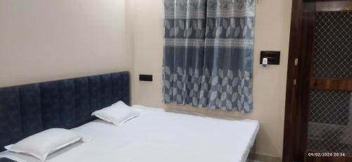 a bedroom with a white bed and a window at Hari Har vila house Air conditioner Full vila for rent in Ujjain