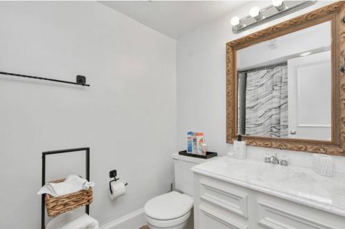 een badkamer met een toilet en een spiegel bij 2BR Central Montrose Townhome in Houston