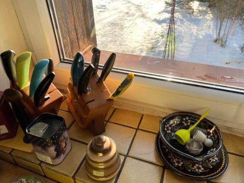 a kitchen counter with a knife holder next to a window at zielonapogoda in Lądek-Zdrój