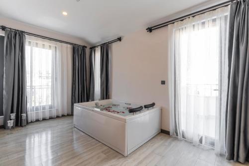 a large white room with large windows and a table at IRENIC HOTEL in Antalya