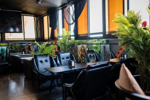 a restaurant with chairs and tables and plants at ZAN Lodge in Male City