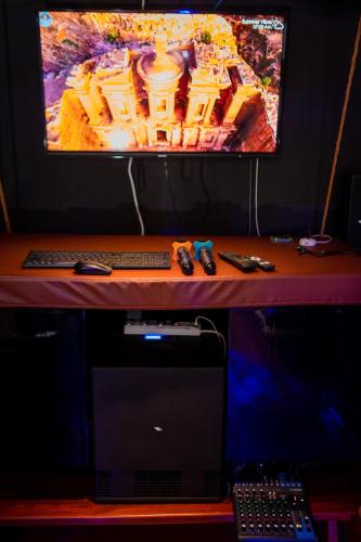 a desk with a computer monitor and a laptop on it at ZAN Lodge in Male City