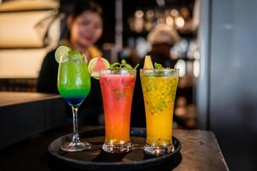 three drinks on a tray on a table at ZAN Lodge in Male City