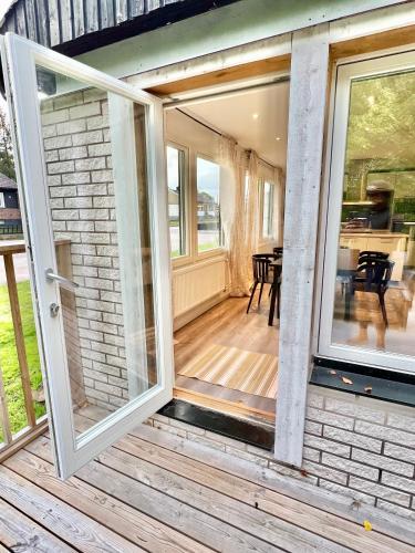 an open sliding glass door on a house at Villa Kosta in Kosta