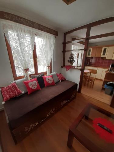 a living room with a couch and a table at Na Równi in Zakopane