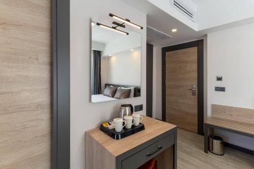 a bathroom with a sink and a mirror at IRENIC HOTEL in Antalya