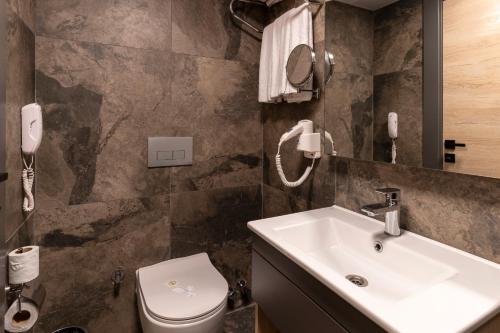 a bathroom with a sink and a toilet at IRENIC HOTEL in Antalya