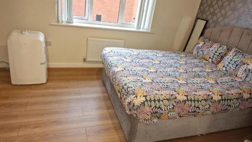 a bedroom with a bed and a window and a radiator at Stunning 2-Bed House in Manchester with canal view in Manchester