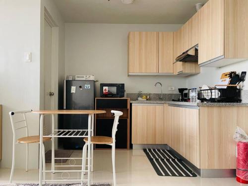 a kitchen with a table and a refrigerator at * * WV 1 Minimalist Studio in Iloilo City