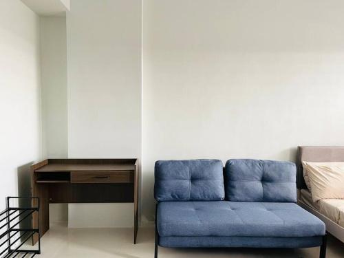 a blue couch in a room with a desk at * * WV 1 Minimalist Studio in Iloilo City