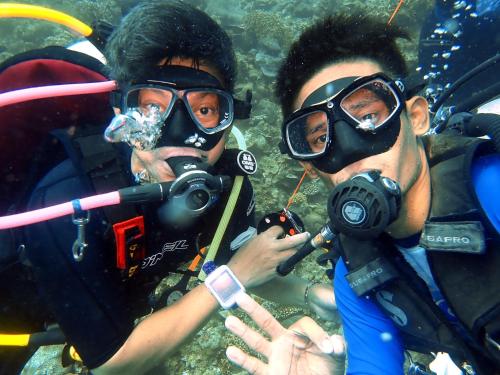 two people wearing masks and diving equipment in the water at CasaDel Beach House in Mabini