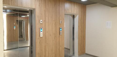 a row of elevators in a room with wooden walls at Love Journey Tbilisi in Tbilisi City