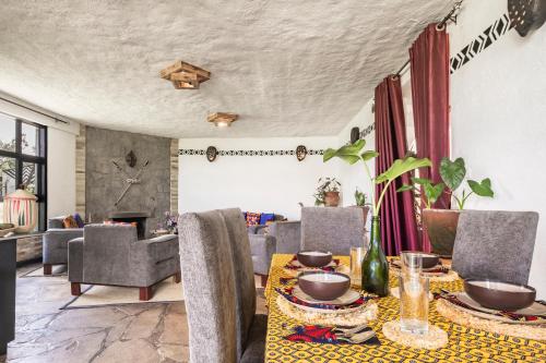 a dining room with a table and chairs at Kinigi Cottage in Kinigi