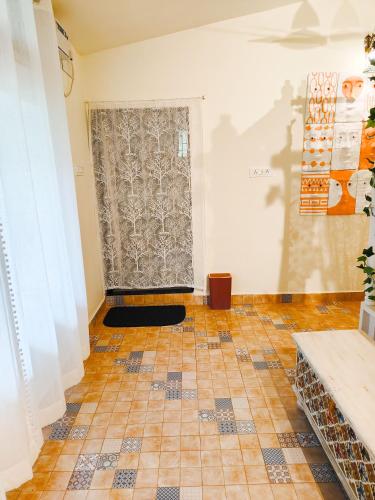a room with a tiled floor and a door at CHATEAU MADEIRA BY GOAN DIARIES in Moira