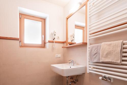 a bathroom with a sink and a mirror at Lüch da Morgnun in San Vigilio Di Marebbe