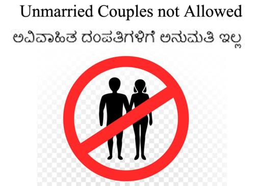 um sinal proibido com um homem e uma mulher em Diamond Lodge em Shivamogga
