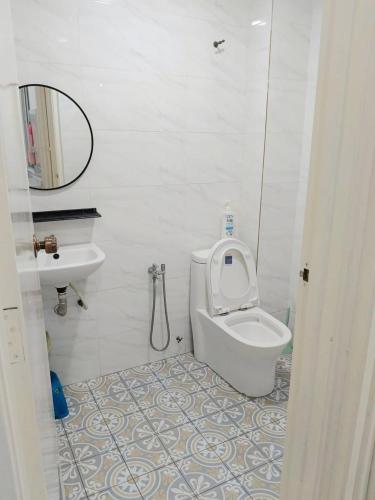 a white bathroom with a toilet and a sink at Rawang Conner lot homestay in Rawang