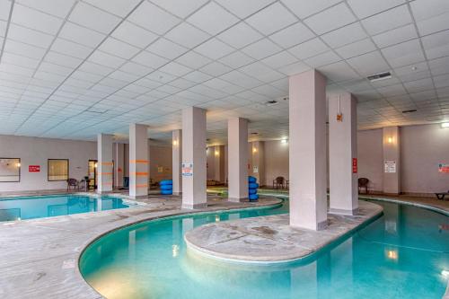 a swimming pool with columns in a building at Park Tower Inn in Pigeon Forge