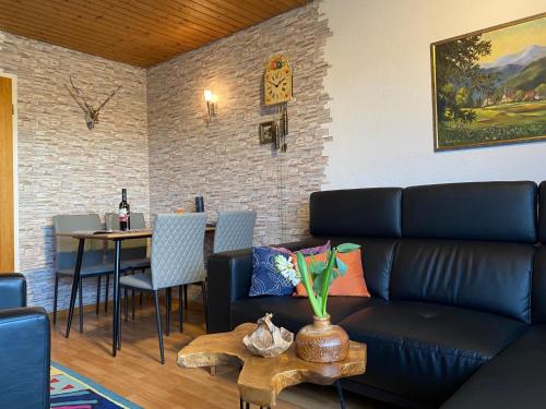 a living room with a couch and a table at Haus Janßen-Wehrle in Titisee-Neustadt