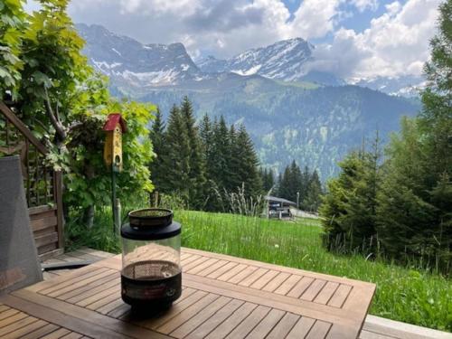 a grill on a table with a view of mountains at Cosy studio on the ski slopes in Gryon