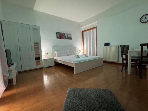 a bedroom with a bed and a table and chairs at Guest House Demma in Rome