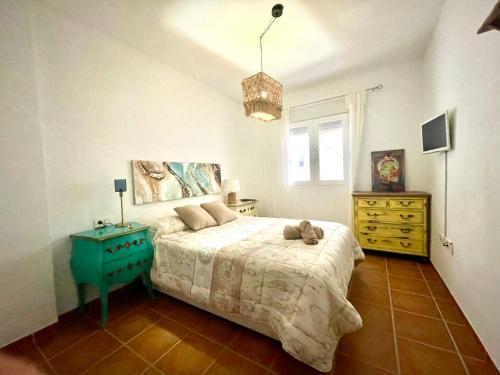 una camera da letto con un letto con un orsacchiotto sopra di CASA AZUL Mojácar a Mojácar