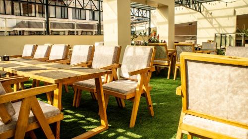 a dining room with wooden tables and chairs at Kathmandu Business Hotel in Kathmandu
