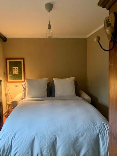 a bedroom with a large bed with white pillows at Il Riccio appartamento in Cernobbio