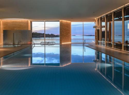 a swimming pool with a view of the water at Regatta Seaside Suite in Hanko in Hanko