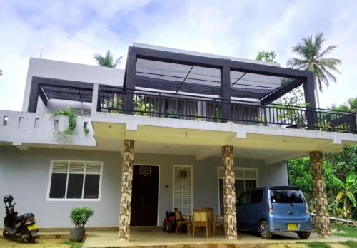 medahena في تانجالي: منزل مع شرفة وسيارة فان متوقفة في الأمام