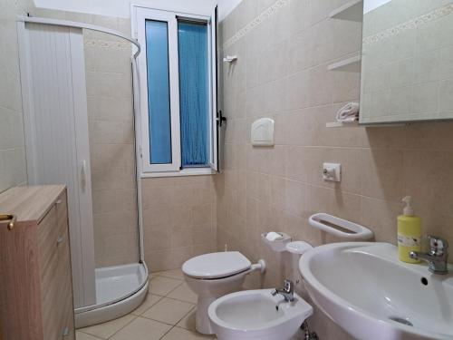a bathroom with a sink and a toilet and a shower at Villa Giulia in Ostuni