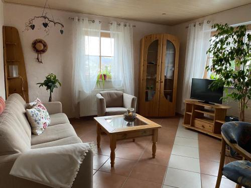 a living room with a couch and a coffee table at Fischers Ferienhaus in Alken