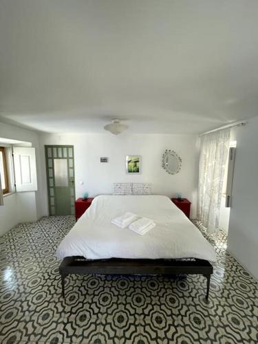 a bedroom with a large bed in a room at Zen House in Sines