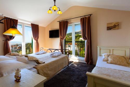 a hotel room with two beds and a window at Villa Filip Spa & Relax Makarska in Makarska