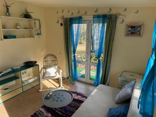 a room with a bed and a chair and a window at Chata se zahradou v Liberci in Liberec
