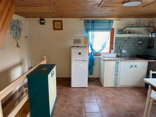a small kitchen with a refrigerator and a stove at Chata se zahradou v Liberci in Liberec