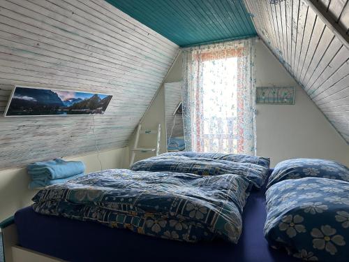 a bedroom with two beds and a window at Chata se zahradou v Liberci in Liberec