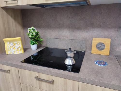 a kitchen counter with a coffee maker on it at Casetta via Lazio in Mesagne
