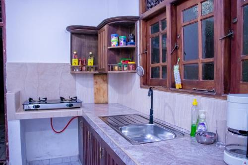 a kitchen with a sink and a counter top at DiNi Galle in Galle