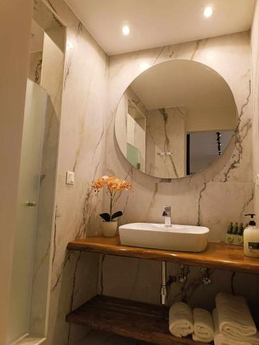 a bathroom with a sink and a mirror at Iatrou city home in Volos