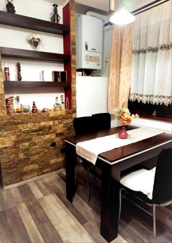 a dining room with a table and chairs at E'milu Residence in Ghimbav