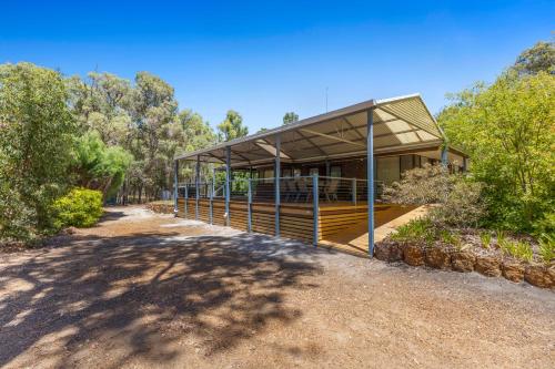 a house with a large deck in the woods at Diamond Lake Escape in Collie