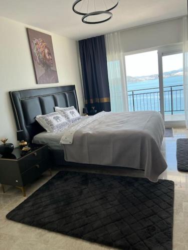a bedroom with a large bed and a balcony at Villa FABAY Bodrum in Milas