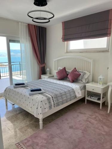 a bedroom with a bed and a large window at Villa FABAY Bodrum in Milas