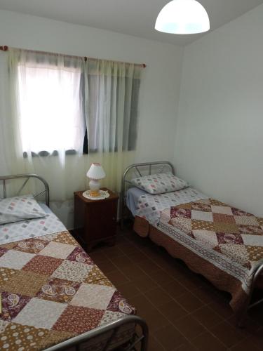 a room with two beds and a window at La Evelia in Salta