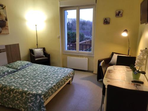a hotel room with a bed and a window at Studio Rez de Chaussée Meublé in La Roche-Posay