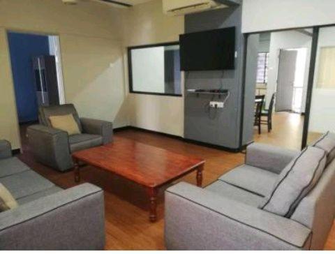 a living room with two couches and a table and a tv at PD Corus myHoliday Homes & Apartments in Port Dickson