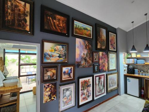 a wall full of pictures on a wall at Bendor Garden Flat in Polokwane