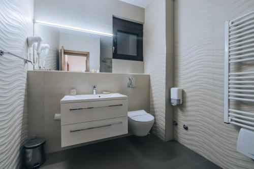 a bathroom with a white sink and a toilet at Apartments Kuce Lekovica Beach & snack bar- Bistro in Bar